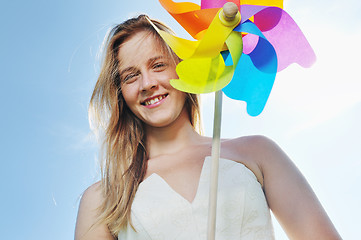 Image showing beautiful bride outdoor with colorful windmill toy