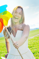 Image showing beautiful bride outdoor with colorful windmill toy