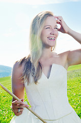 Image showing beautiful bride outdoor with colorful windmill toy