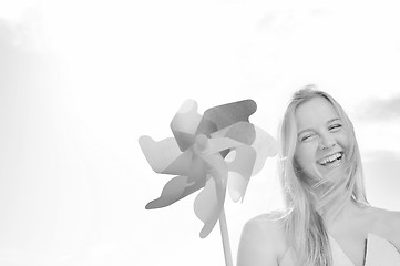 Image showing beautiful bride outdoor with colorful windmill toy