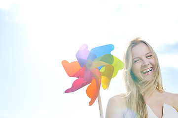 Image showing beautiful bride outdoor with colorful windmill toy