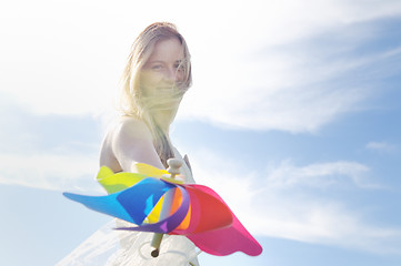 Image showing beautiful bride outdoor with colorful windmill toy