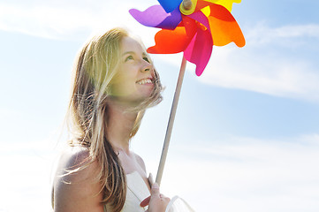 Image showing beautiful bride outdoor with colorful windmill toy