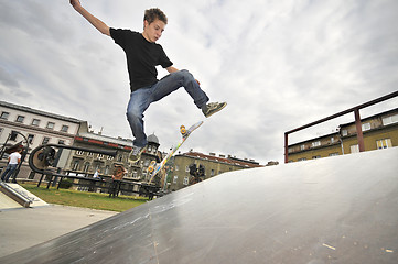 Image showing Boy practicing skate in a skate park - isolated