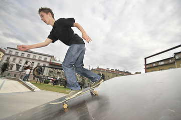 Image showing Boy practicing skate in a skate park - isolated