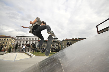 Image showing Boy practicing skate in a skate park - isolated