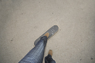 Image showing Foot standing on skate board