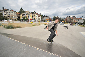 Image showing Boy practicing skate in a skate park - isolated