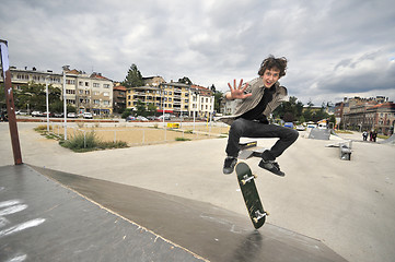 Image showing Boy practicing skate in a skate park - isolated