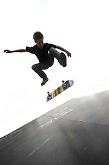 Image showing Boy practicing skate in a skate park - isolated