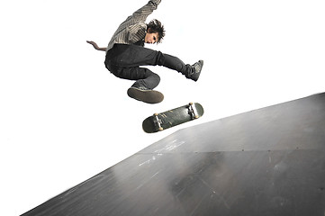 Image showing Boy practicing skate in a skate park - isolated