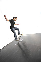 Image showing Boy practicing skate in a skate park - isolated