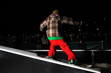 Image showing freestyle snowboarder jump in air at night