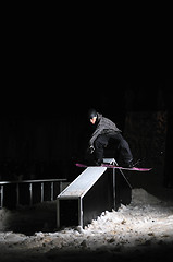 Image showing freestyle snowboarder jump in air at night