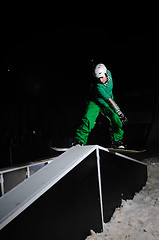 Image showing freestyle snowboarder jump in air at night