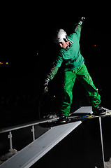 Image showing freestyle snowboarder jump in air at night