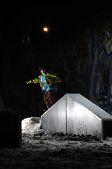 Image showing freestyle snowboarder jump in air at night