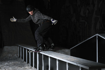 Image showing freestyle snowboarder jump in air at night