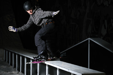 Image showing freestyle snowboarder jump in air at night