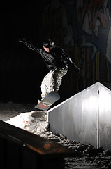 Image showing freestyle snowboarder jump in air at night