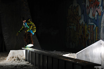 Image showing freestyle snowboarder jump in air at night