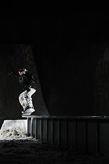 Image showing freestyle snowboarder jump in air at night