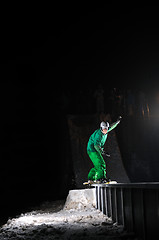 Image showing freestyle snowboarder jump in air at night