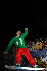 Image showing freestyle snowboarder jump in air at night