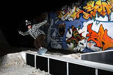 Image showing freestyle snowboarder jump in air at night