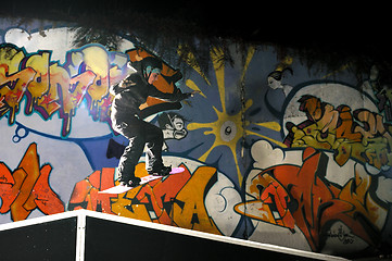 Image showing freestyle snowboarder jump in air at night