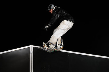 Image showing freestyle snowboarder jump in air at night