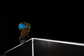 Image showing freestyle snowboarder jump in air at night