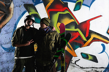 Image showing two skiirs standing against colorful background