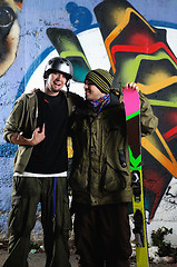 Image showing two skiirs standing against colorful background