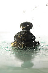 Image showing isolated wet zen stones with splashing  water drops