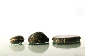 Image showing isolated wet zen stones with splashing  water drops