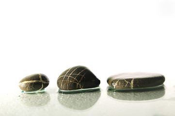 Image showing isolated wet zen stones with splashing  water drops