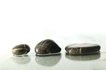 Image showing isolated wet zen stones with splashing  water drops