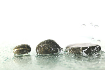 Image showing isolated wet zen stones with splashing  water drops