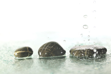 Image showing isolated wet zen stones with splashing  water drops