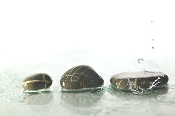 Image showing isolated wet zen stones with splashing  water drops