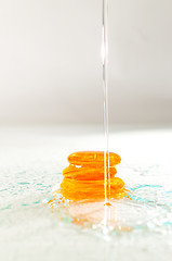 Image showing isolated wet zen stones with splashing  water drops  