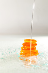 Image showing isolated wet zen stones with splashing  water drops  