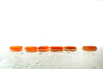 Image showing isolated wet zen stones with splashing  water drops  