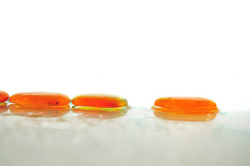 Image showing isolated wet zen stones with splashing  water drops  