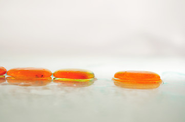 Image showing isolated wet zen stones with splashing  water drops  