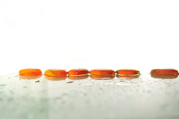 Image showing isolated wet zen stones with splashing  water drops  