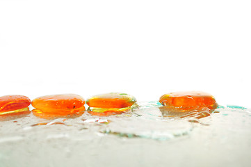 Image showing isolated wet zen stones with splashing  water drops  