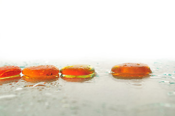 Image showing isolated wet zen stones with splashing  water drops  