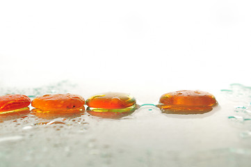 Image showing isolated wet zen stones with splashing  water drops  